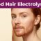 Three-quarter portrait of a fair-skinned woman with copper-red facial hair beneath a purple headline band.