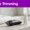 A guarded trimmer, folded towel, and moisturizer sit on a bathroom counter beneath a purple headline.