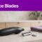 A body groomer and worn blade rest on a bathroom counter beneath a purple “Replace Blades” banner.